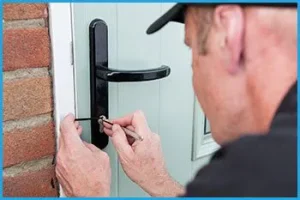 Locksmith repairing a door lock